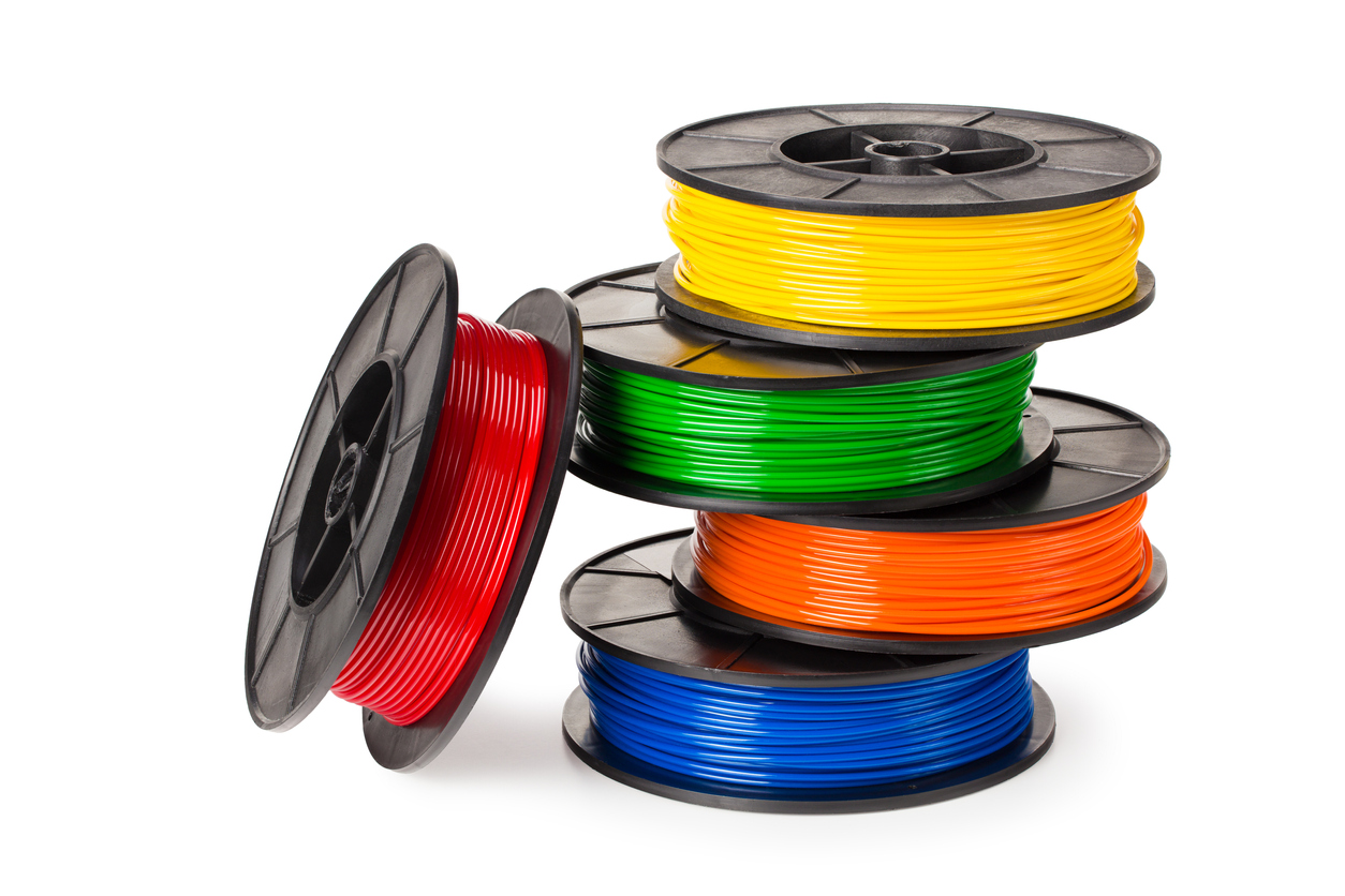 Black, red, blue, green, violet, orange, yellow, white filament 3d printer isolated on white background